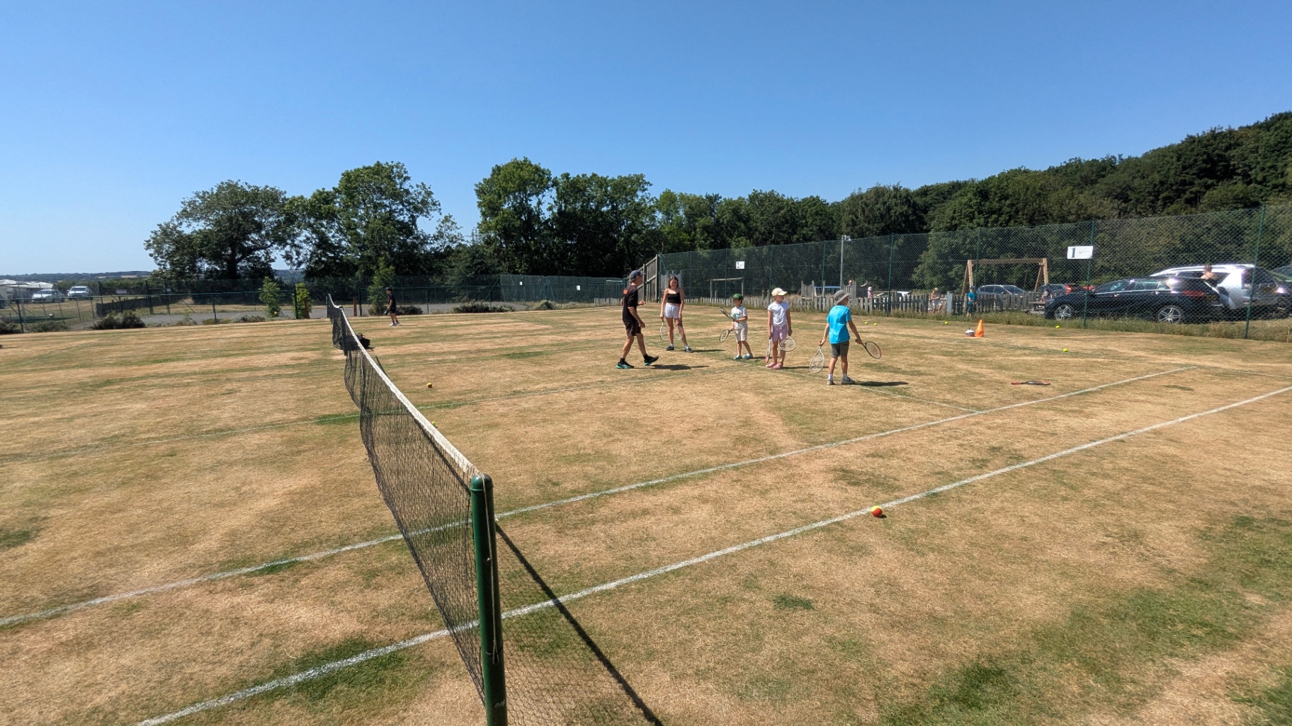Group session warming up on the grass court